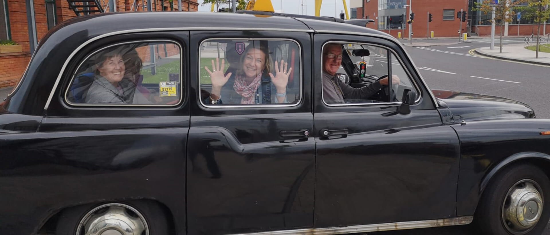 Vagabond Tour group setting off on a Black Cab tour of Belfast, Northern Ireland