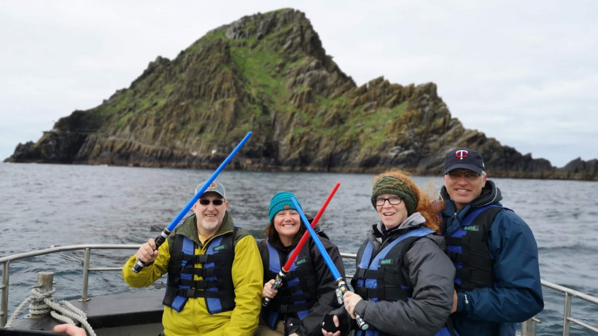 Vagabond tour guests celebrating May The 4th Star Wars festival off Little Skellig island in Ireland with lightsabers