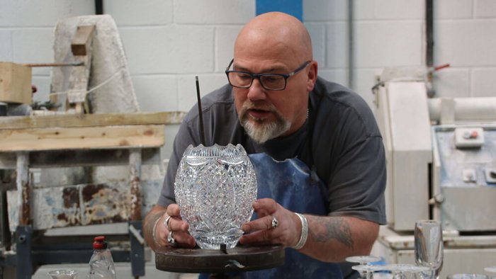 Sean Daly of Dingel Crystal showing off his vase he hand cut