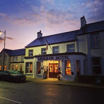 Exterior facade of Arnolds Hotel at night in Dunfanaghy, Ireland