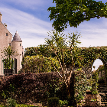 The gardens of ballygally castle with a blue sky