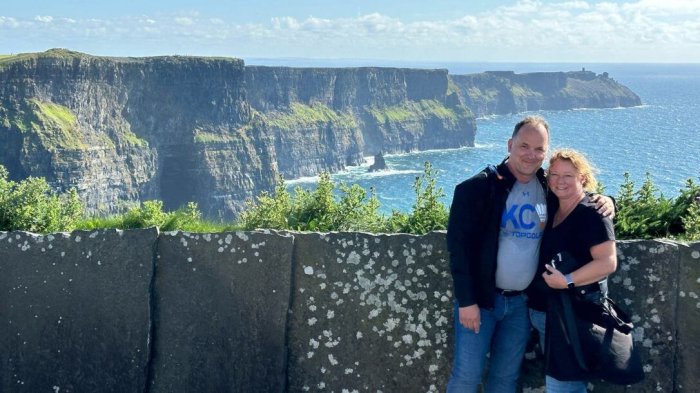 Experience the Cliffs of Moher, soaring 700 feet above the sea A couple posing in front of the cliffs of moher