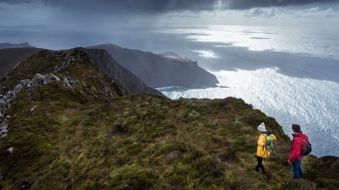 Stand in awe of Europe's highest accessible sea cliffs Hiking couple at Slieve League in Donegal