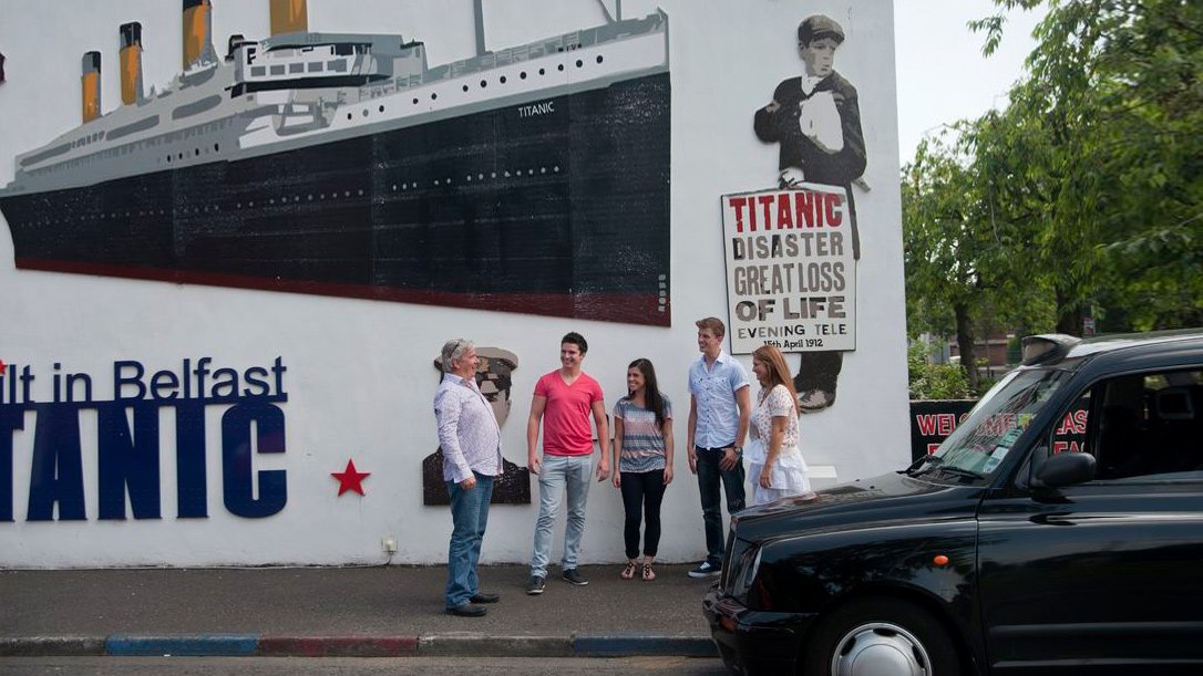 Black Cab tour in Belfast in front of  Titanic mural