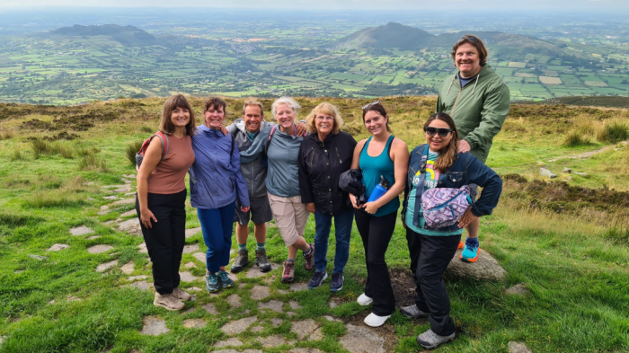 Explore Ireland's highest passage tomb A group of guests on tour at the top of Slieve Gullion
