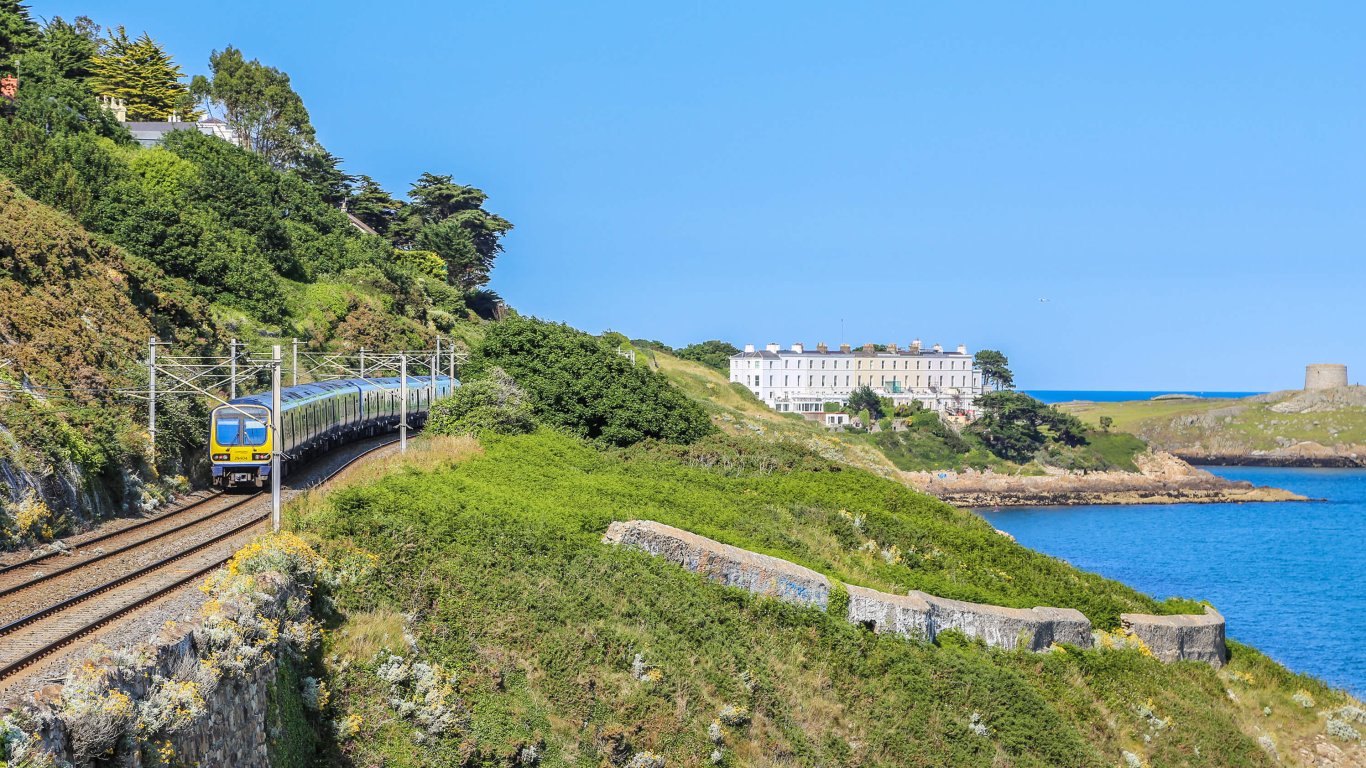 A train passing through Killiney with a view of Dalkey Island in the background The DART passing through Killiney in the sunshine with a view of Dalkey Island in the distance